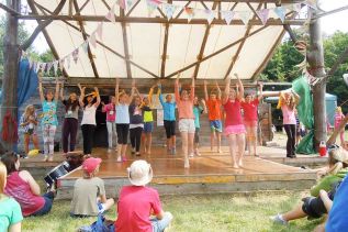 Band leader Teilhard Frost leads the Blue Skies Camp Choir at their Friday showcase in Clarendon)